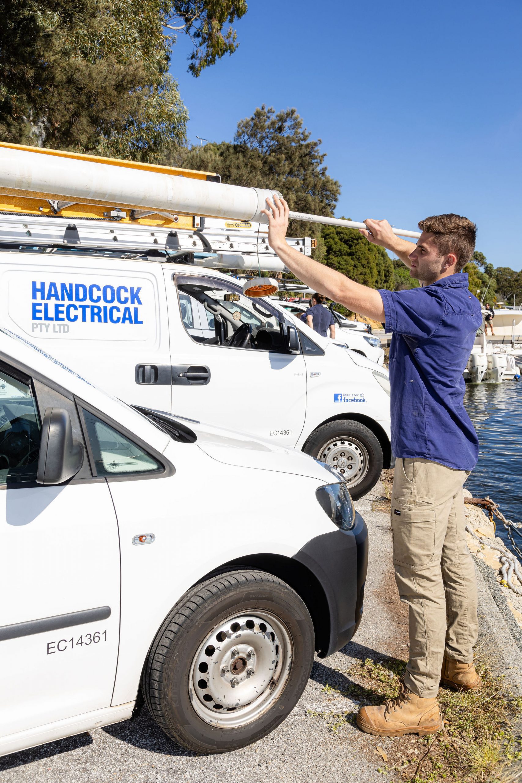An electrician in Perth from Handcock Electrical securing equipment on a service vehicle, ensuring readiness for professional electrical work.
